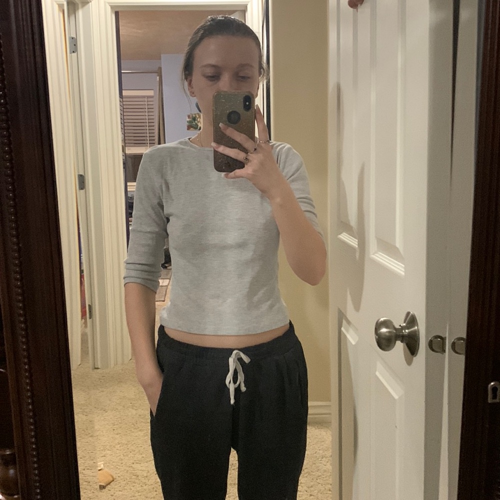 Light gray colors crop top with elbow lengthed sleeves.